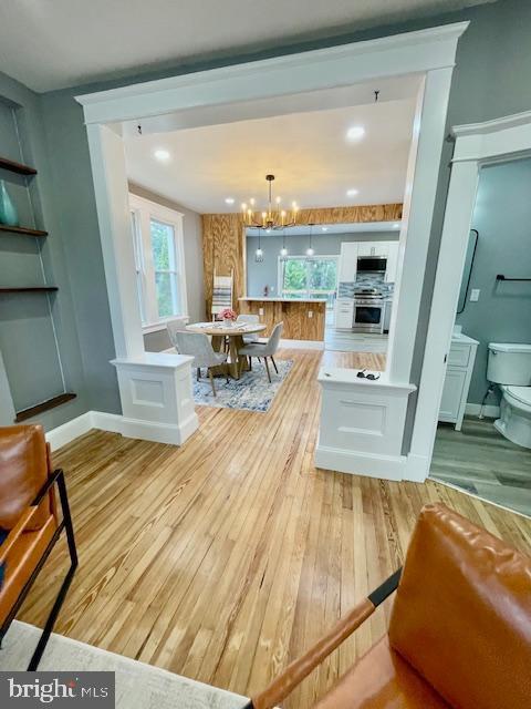 25 Elmont Ave, Baltimore, MD 21206 - living room with light wood-type flooring, a chandelier, and plenty of natural light