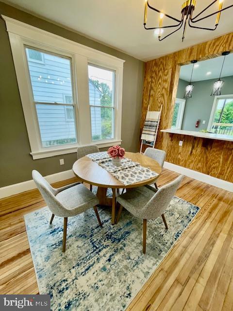 25 Elmont Ave, Baltimore, MD 21206 - dining area with a chandelier, baseboards, and wood finished floors