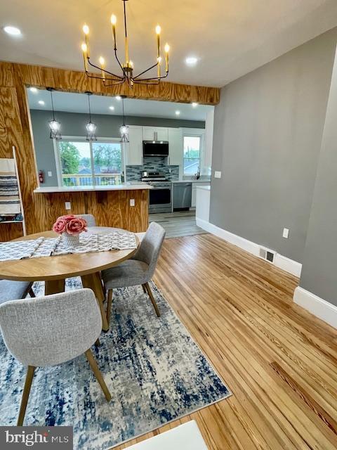 25 Elmont Ave, Baltimore, MD 21206 - dining space featuring a chandelier, baseboards, light wood-style floors, and recessed lighting