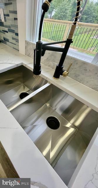 25 Elmont Ave, Baltimore, MD 21206 - kitchen view of a sink and light stone countertops