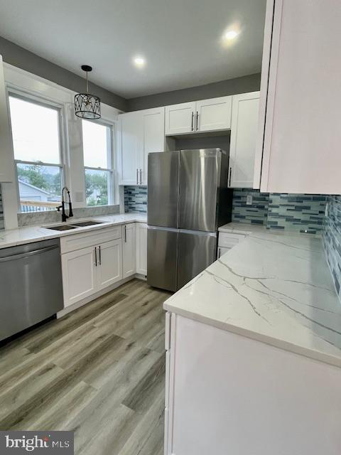 25 Elmont Ave, Baltimore, MD 21206 - kitchen with stainless steel appliances, a sink, white cabinetry, tasteful backsplash, and recessed lighting