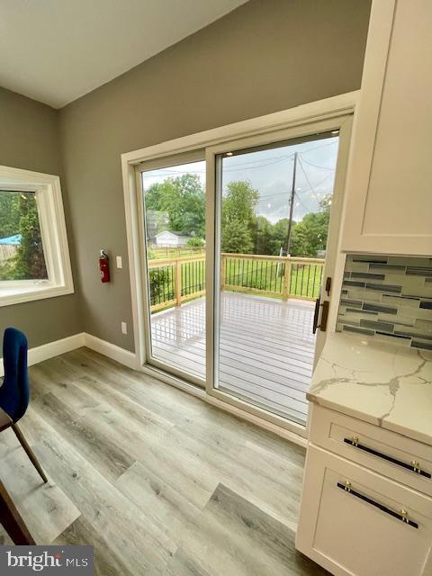 25 Elmont Ave, Baltimore, MD 21206 - doorway with healthy amount of natural light, light wood-type flooring, and baseboards