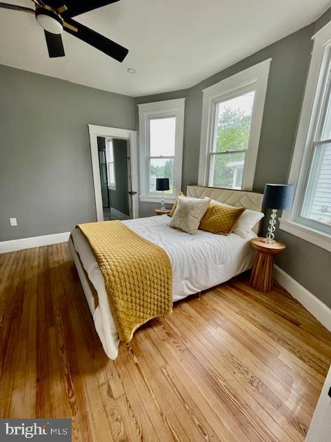 25 Elmont Ave, Baltimore, MD 21206 - bedroom with multiple windows, wood finished floors, and baseboards