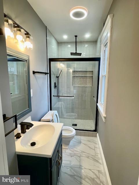 25 Elmont Ave, Baltimore, MD 21206 - full bathroom with baseboards, marble finish flooring, a shower stall, vanity, and toilet