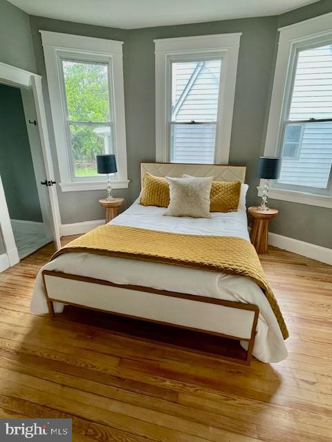25 Elmont Ave, Baltimore, MD 21206 - bedroom featuring baseboards, multiple windows, and wood finished floors