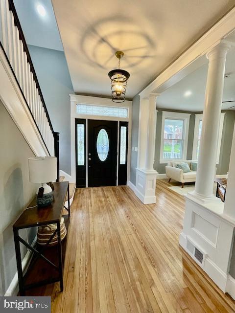 25 Elmont Ave, Baltimore, MD 21206 - foyer with decorative columns, light wood-style floors, stairway, and baseboards