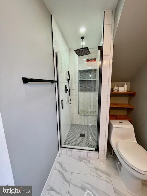 25 Elmont Ave, Baltimore, MD 21206 - bathroom with marble look tile flooring, toilet, and a stall shower
