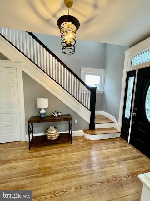 25 Elmont Ave, Baltimore, MD 21206 - entryway featuring stairs, wood-type flooring, plenty of natural light, and a chandelier