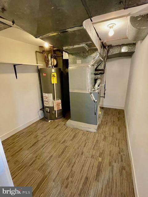 25 Elmont Ave, Baltimore, MD 21206 - finished basement featuring gas water heater, baseboards, heating unit, and wood finished floors
