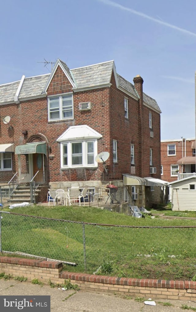 2257 Disston St, Philadelphia, PA 19149 - rear view of house with brick siding and a chimney