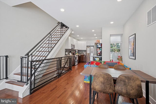 1322 N Hollywood St, Philadelphia, PA 19121 - dining space featuring dark wood-style flooring, recessed lighting, stairway, and baseboards
