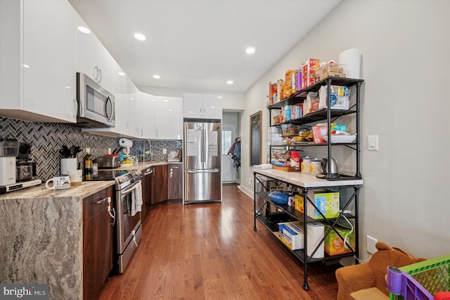 1322 N Hollywood St, Philadelphia, PA 19121 - kitchen with appliances with stainless steel finishes, modern cabinets, white cabinetry, wood finished floors, and backsplash