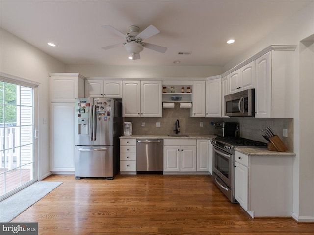 131 Stirrup Cir, West Chester, PA 19382 - kitchen with stainless steel appliances, a sink, open shelves, white cabinetry, and a ceiling fan