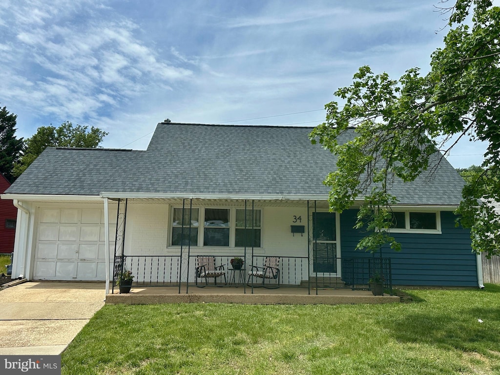 34 Thomas Rd, Glen Burnie, MD 21060 - cape cod house with covered porch, an attached garage, roof with shingles, a front yard, and driveway