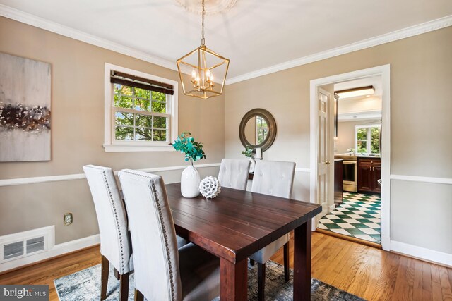 3122 1st St N, Arlington, VA 22201 - dining space featuring a chandelier, light wood-type flooring, ornamental molding, and baseboards