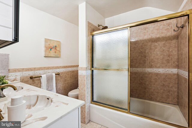 3122 1st St N, Arlington, VA 22201 - full bath featuring bath / shower combo with glass door, vanity, tile walls, a wainscoted wall, and tile patterned floors