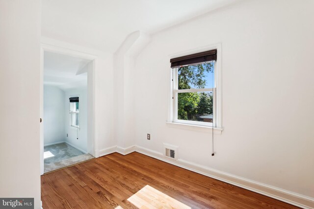 3122 1st St N, Arlington, VA 22201 - empty room featuring wood finished floors, healthy amount of natural light, and baseboards