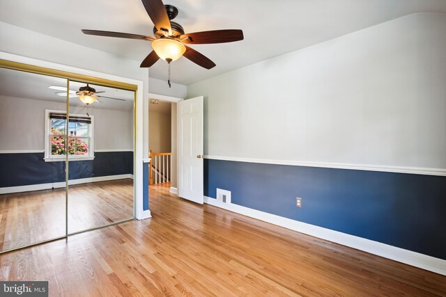 3122 1st St N, Arlington, VA 22201 - unfurnished bedroom with wood finished floors, a closet, baseboards, and ceiling fan