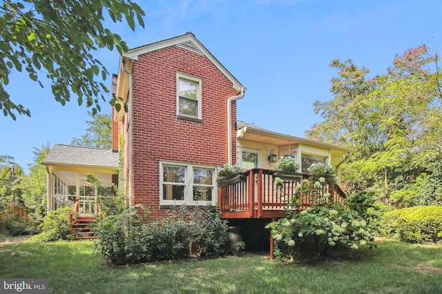 3122 1st St N, Arlington, VA 22201 - back of property featuring a deck, brick siding, and a lawn