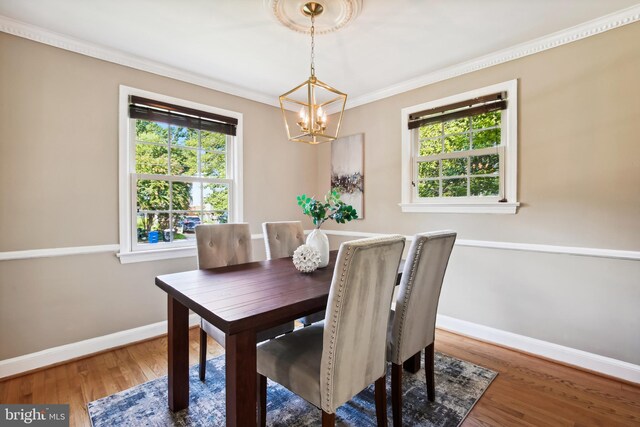 3122 1st St N, Arlington, VA 22201 - dining area featuring a chandelier, baseboards, wood finished floors, and crown molding