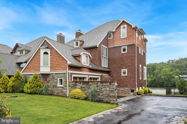 236 River Rd, Gladwyne, PA 19035 - view of property exterior with a chimney, a lawn, stone siding, roof with shingles, and driveway