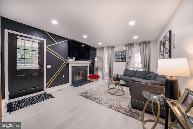 15210 Emory Ct, Bowie, MD 20716 - living area featuring wood finished floors, a fireplace with flush hearth, recessed lighting, and baseboards