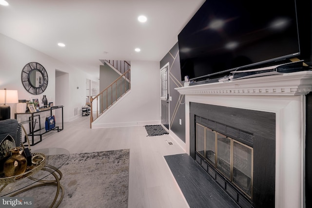 15210 Emory Ct, Bowie, MD 20716 - living area featuring a fireplace with flush hearth, wood finished floors, stairway, recessed lighting, and baseboards