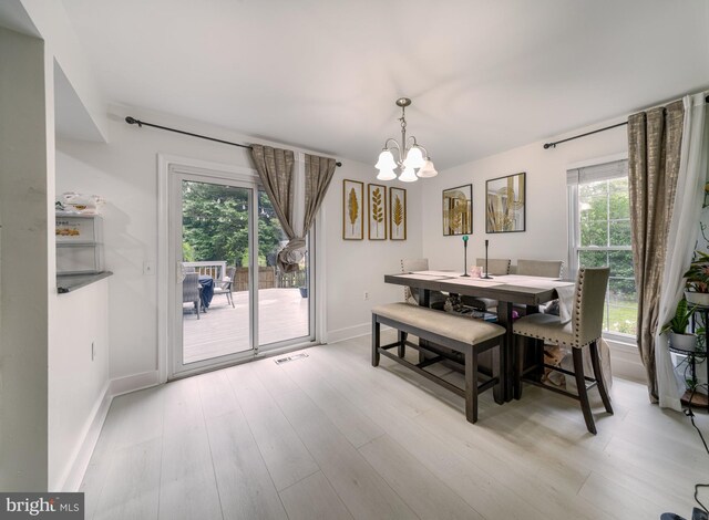 15210 Emory Ct, Bowie, MD 20716 - dining area featuring a chandelier, plenty of natural light, baseboards, and light wood-style floors