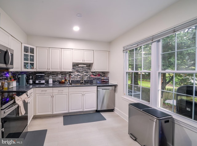 15210 Emory Ct, Bowie, MD 20716 - kitchen with appliances with stainless steel finishes, a sink, backsplash, white cabinets, and baseboards