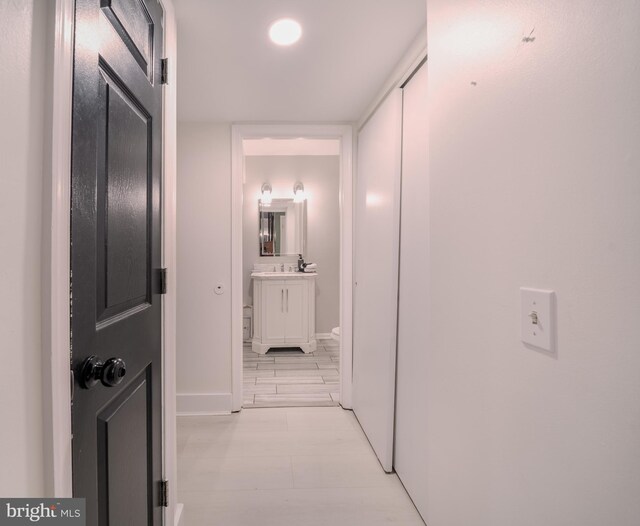 15210 Emory Ct, Bowie, MD 20716 - corridor featuring baseboards and a sink