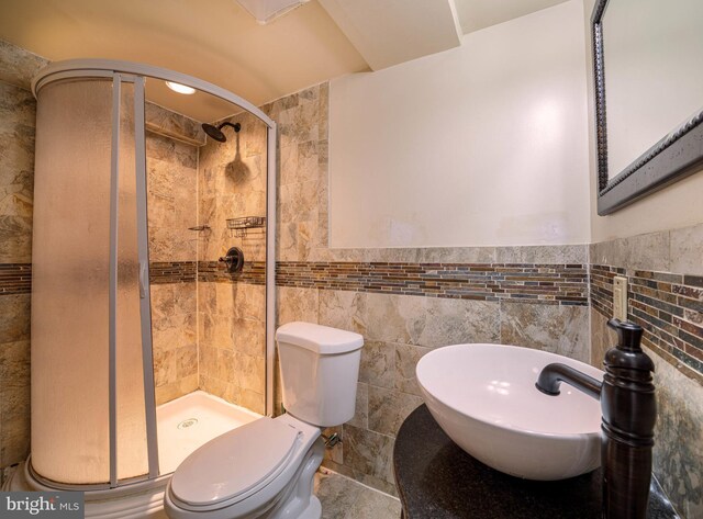 15210 Emory Ct, Bowie, MD 20716 - full bathroom featuring a stall shower, tile walls, toilet, a sink, and wainscoting