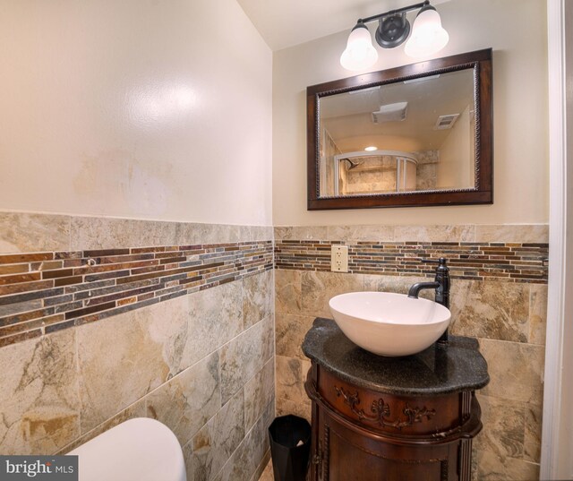 15210 Emory Ct, Bowie, MD 20716 - bathroom with tile walls, vanity, toilet, and wainscoting