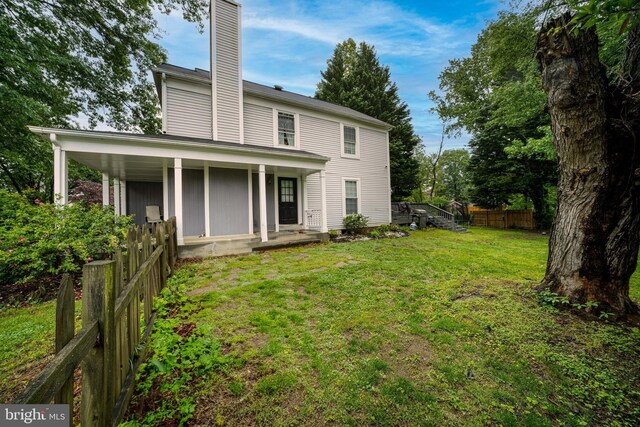 15210 Emory Ct, Bowie, MD 20716 - rear view of house featuring a chimney and a porch
