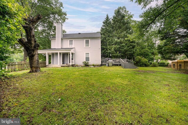 15210 Emory Ct, Bowie, MD 20716 - back of property with a chimney and a wooden deck