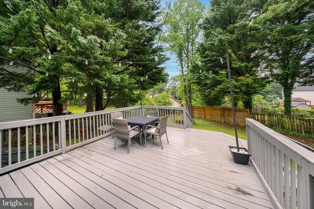 15210 Emory Ct, Bowie, MD 20716 - wooden deck with outdoor dining area and view of wooded area