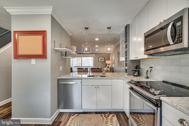 15656 Cliff Swallow Way, Rockville, MD 20853 - kitchen with appliances with stainless steel finishes, dark wood-style floors, light stone countertops, backsplash, and ornamental molding