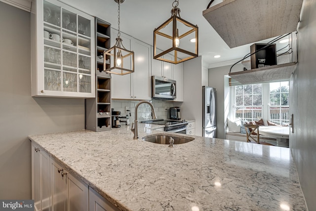 15656 Cliff Swallow Way, Rockville, MD 20853 - kitchen with stainless steel appliances, light stone counters, decorative backsplash, glass insert cabinets, and ornamental molding