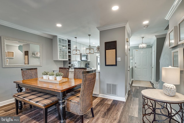 15656 Cliff Swallow Way, Rockville, MD 20853 - dining room with dark wood-style flooring, crown molding, recessed lighting, and a chandelier