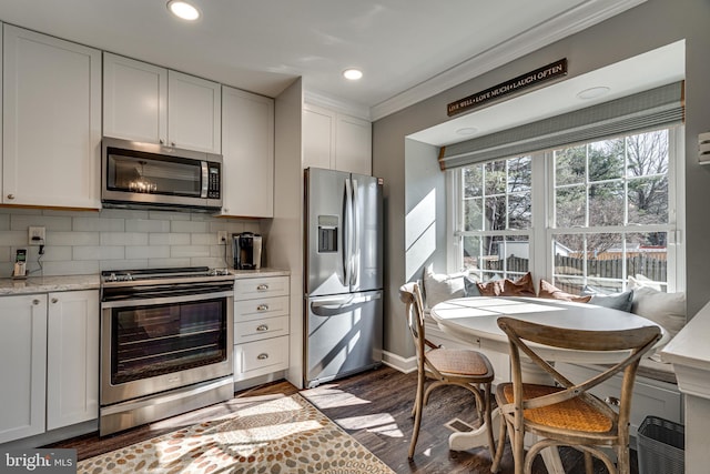 15656 Cliff Swallow Way, Rockville, MD 20853 - kitchen featuring appliances with stainless steel finishes, ornamental molding, tasteful backsplash, white cabinetry, and recessed lighting