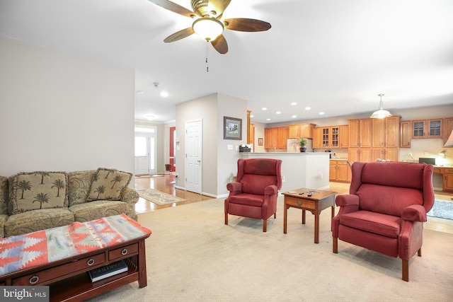 living area featuring recessed lighting, a ceiling fan, light colored carpet, and baseboards