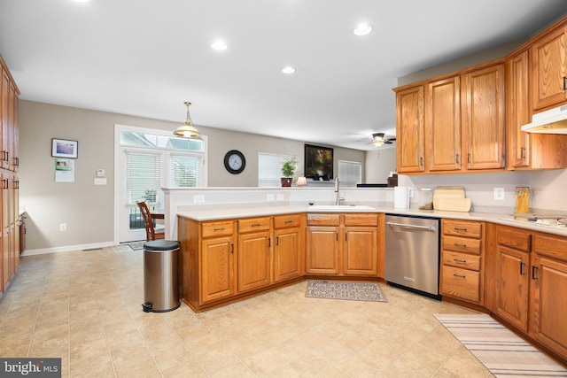 kitchen featuring stainless steel dishwasher, a sink, a peninsula, light countertops, and recessed lighting