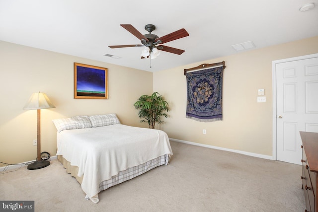 bedroom with light colored carpet, baseboards, and ceiling fan
