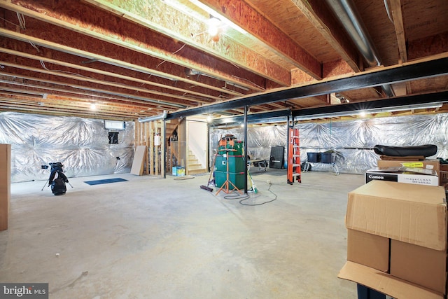 unfinished below grade area featuring stairway