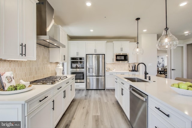 6501 Clubhouse Dr, Laurel, MD 20708 - kitchen featuring stainless steel appliances, wall chimney exhaust hood, a sink, backsplash, and white cabinetry