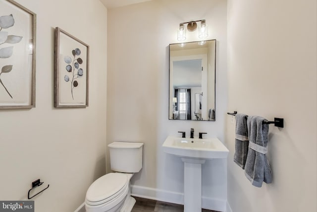 6501 Clubhouse Dr, Laurel, MD 20708 - half bathroom featuring toilet, baseboards, and a sink