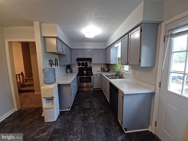 189 Columbia Dr, Kearneysville, WV 25430 - kitchen featuring stainless steel range with electric cooktop, dishwasher, a textured ceiling, a sink, and light countertops