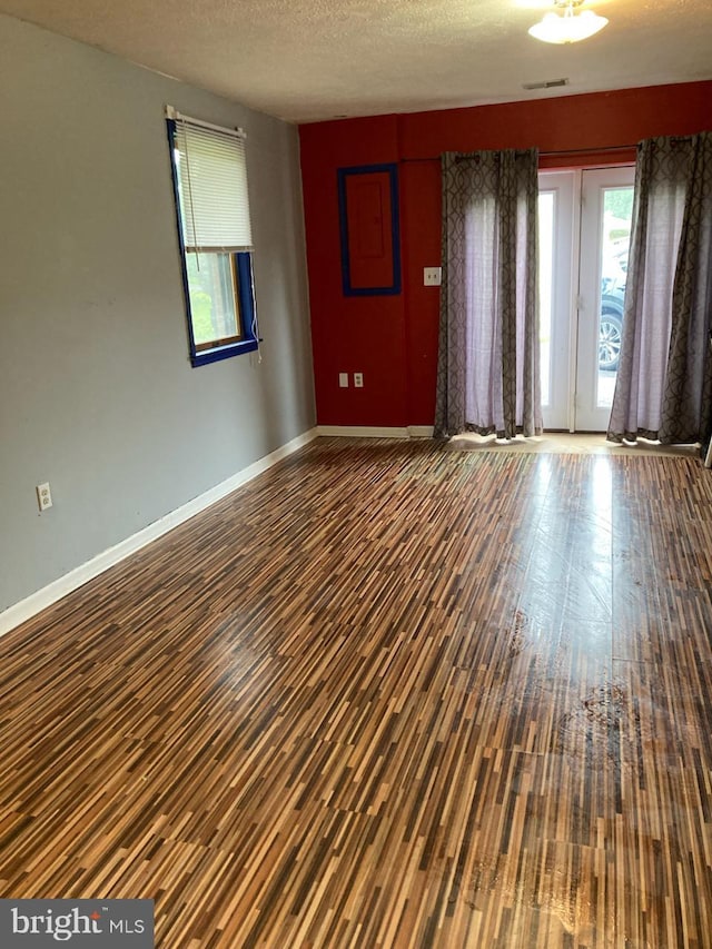 189 Columbia Dr, Kearneysville, WV 25430 - empty room with plenty of natural light, wood finished floors, baseboards, and a textured ceiling
