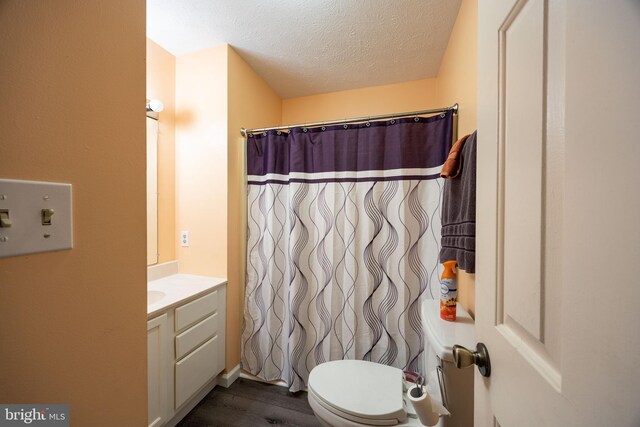 189 Columbia Dr, Kearneysville, WV 25430 - full bath with vanity, toilet, wood finished floors, a textured ceiling, and a shower with shower curtain