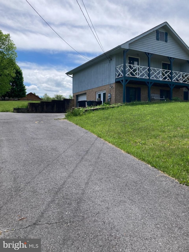 189 Columbia Dr, Kearneysville, WV 25430 - view of property exterior with driveway, an attached garage, brick siding, and a lawn
