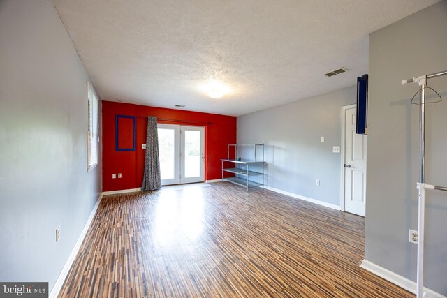 189 Columbia Dr, Kearneysville, WV 25430 - unfurnished living room with wood finished floors, baseboards, and a textured ceiling